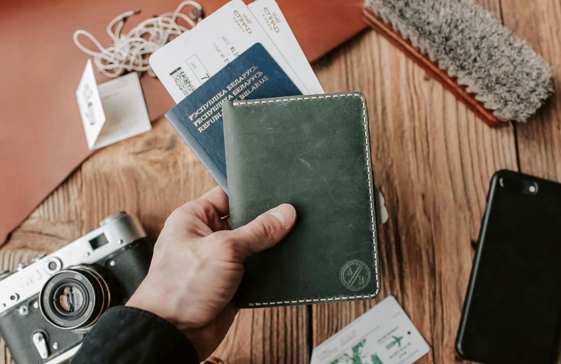 Person holding passport and boarding pass. Travel insurance policy for Schengen visa requirements